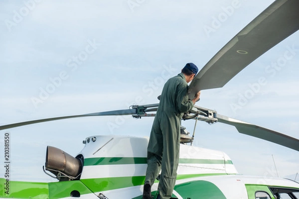 Fototapeta Pilot Check befor flight a helicopter Engine