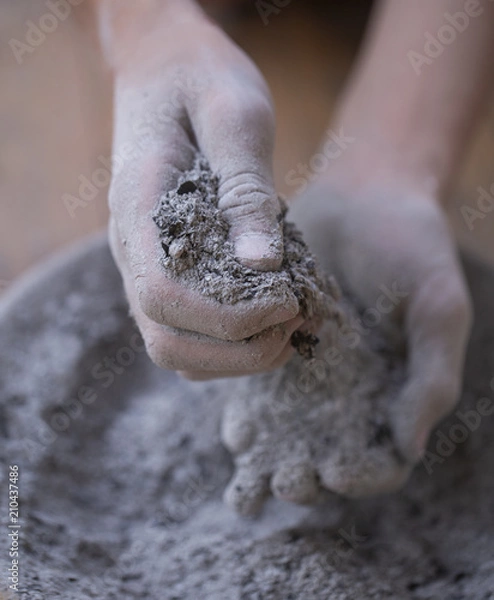 Fototapeta ashes in the hands of a teenager, ashes falling through your fingers