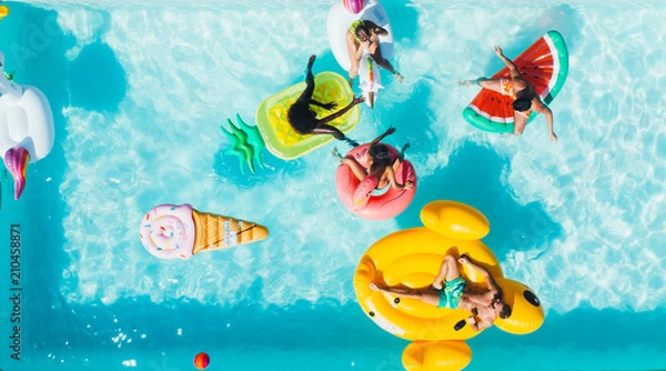 Fototapeta group of friends having fun in the swimming pool