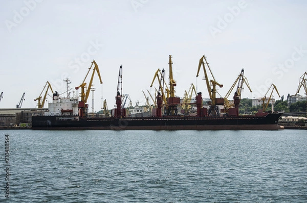 Fototapeta Cargo merchant ship, at the berth of the port terminal.