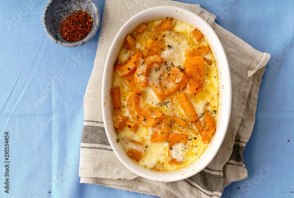 Obraz Roasted squash baked with heavy cream, thyme, white wine and parmesan cheese