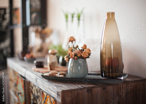 Fototapeta decoration on ancient vintage old commode chest of drawers. Hand made craft gifts, candels and a tree at background. Selective focus
