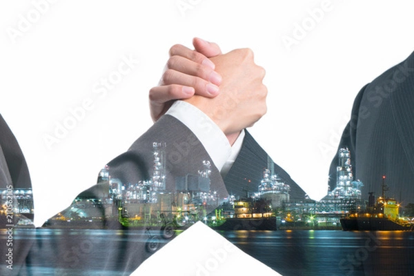 Obraz Double exposure of Business people gripping hands on Power plant with shipping boat at night time.  Investment in Energy concept.