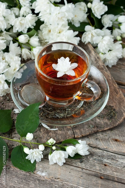 Obraz Jasmine flowers  and cup of tea on rustic background
