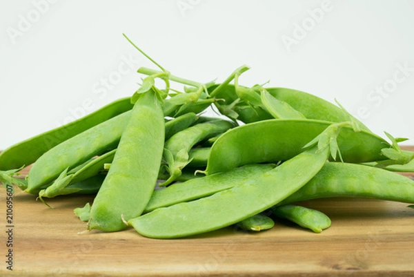 Fototapeta Fresh harvested Snow pea (Pisum sativum var. saccharatum) also known as mangetout organical grown in my garden isolated on wooden background
