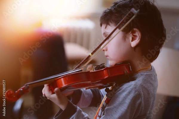 Obraz Child playing violin. Learning concept.