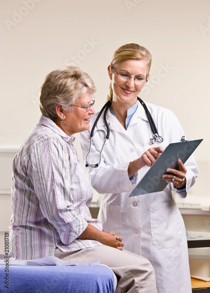 Obraz Doctor explaining medical chart to senior woman