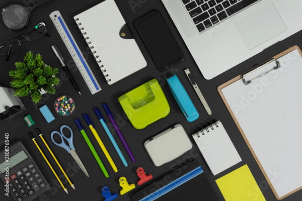 Fototapeta Multiple stationery items and devices for office and school. Top view flat lay of office supply.