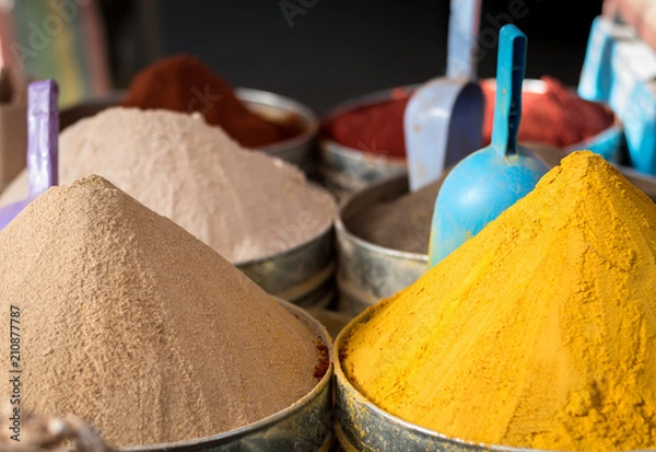 Fototapeta Large piles of exotic colourful spices in moroccan market