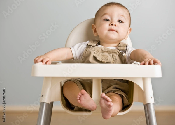 Obraz Baby sitting in highchair