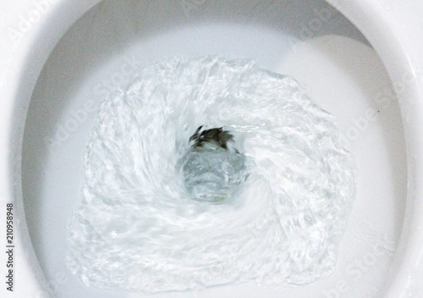 Fototapeta selective focus close up flushing toilet bowl for sanitary, Toilet, Flushing Water, close up, water flushing in toilet, A photo of a white ceramic toilet bowl in the process of washing it off. Ceramic