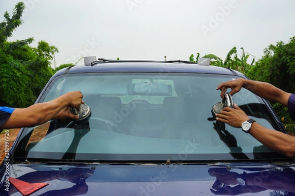 Fototapeta repairing windshield replace windscreen wiper tools fix crack broken front window glass car vehicle services by Glazier. Maintenance repair, replace windshield, windscreen car wiper concept.