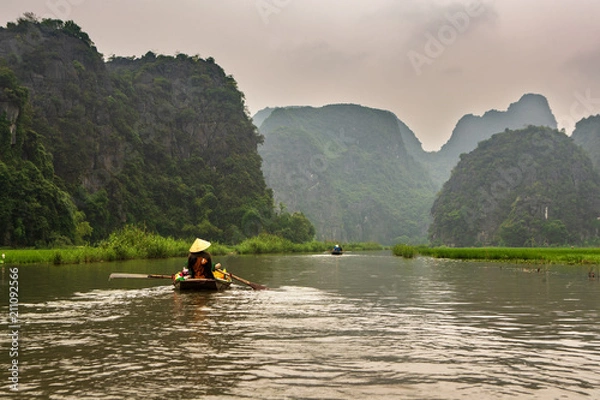 Obraz Touristic boat ride in Hao Lu in Ninh Binh city, Vietnam.It is a famous national park with its rivers and the caves.