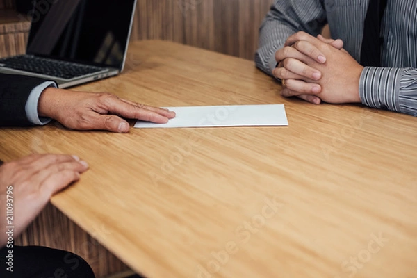 Fototapeta Hand of employer filing final remuneration to employee, letter of resignation, resign concept