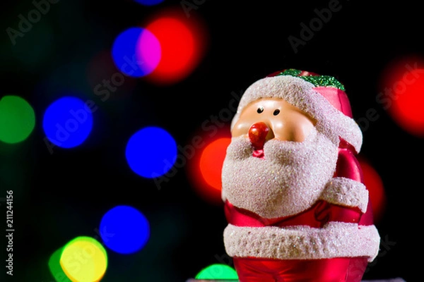Fototapeta Cute Santa Claus on shiny lighting background