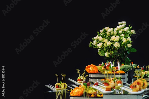 Obraz Fourchette snacks and flowers isolated on a black background