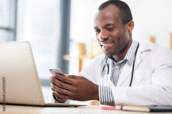 Fototapeta Handsome international man keeping smile on face