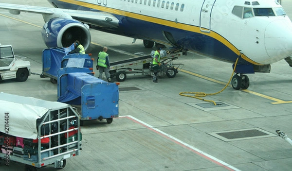 Fototapeta loading baggage onto plane