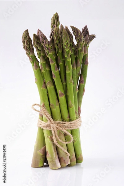 Obraz green asparagus sprouts over white background