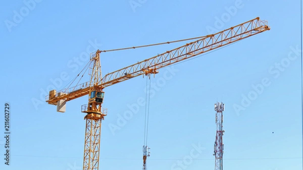 Obraz Construction crane against blue sky.
