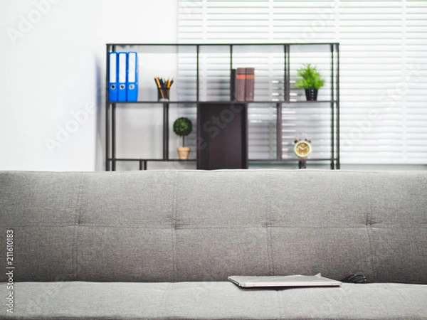 Fototapeta Laptop put on sofa in financial office room.