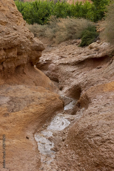 Fototapeta Beautiful landscape of dried salty mountain river with clouds in the sky at La Rambla, La Murada, Orihuela, Spain Mountain area with small river extremely dry and salty. the water created a unique 