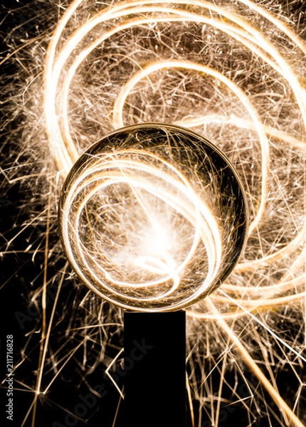 Fototapeta crystal ball with sparklers sparks and electricty