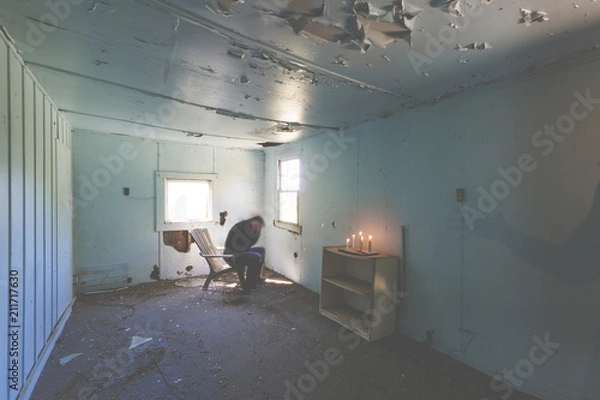 Fototapeta man rocking back and forth out of fear hearing voices depression and alone