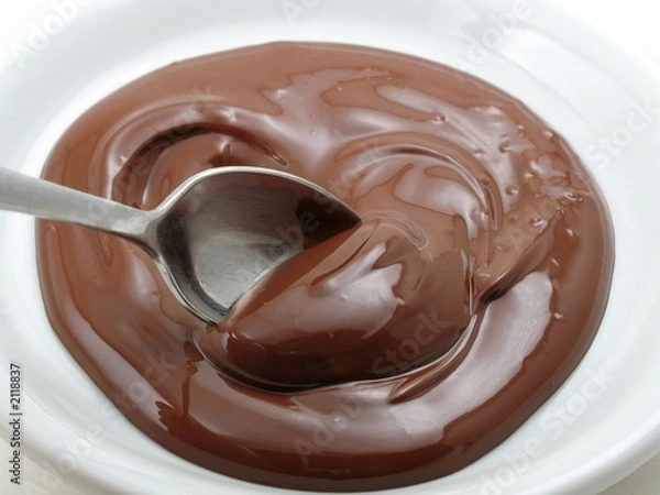 Fototapeta spoon in a pool of chocolate
