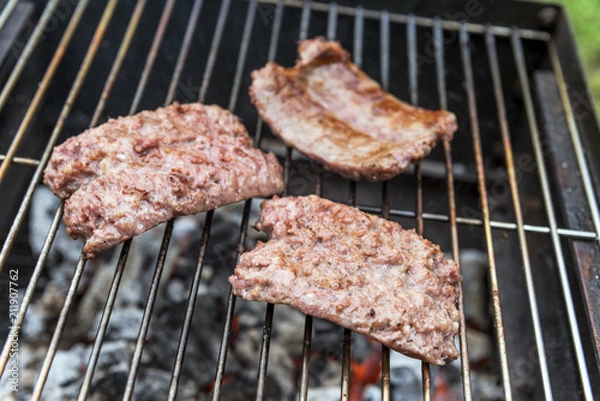 Obraz Sausages cook on the grill