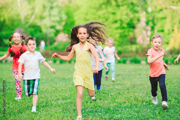 Fototapeta Many different kids, boys and girls running in the park on sunny summer day in casual clothes