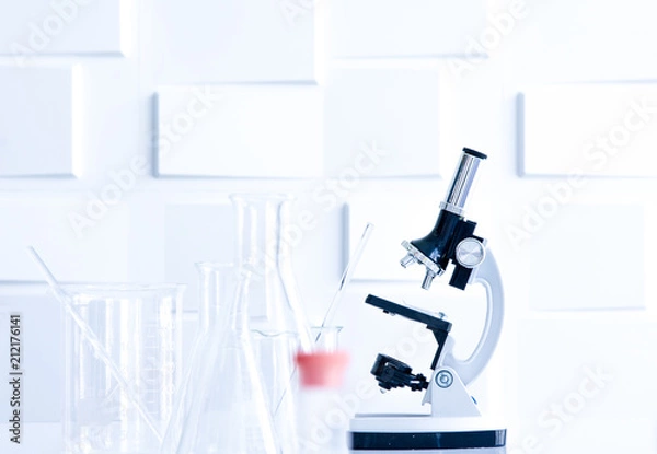 Fototapeta Microscope and glass apparatuses in laboratory for use to analyse in microbiology and chemical
