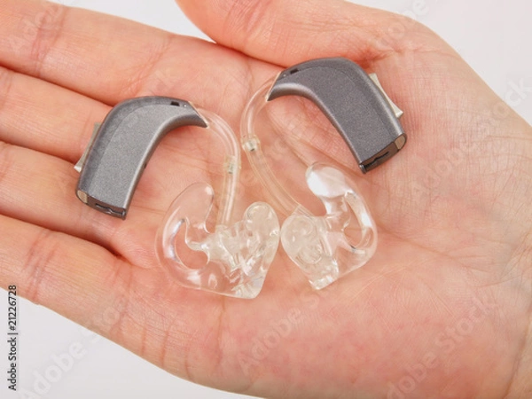 Obraz Hand holding hearing aid