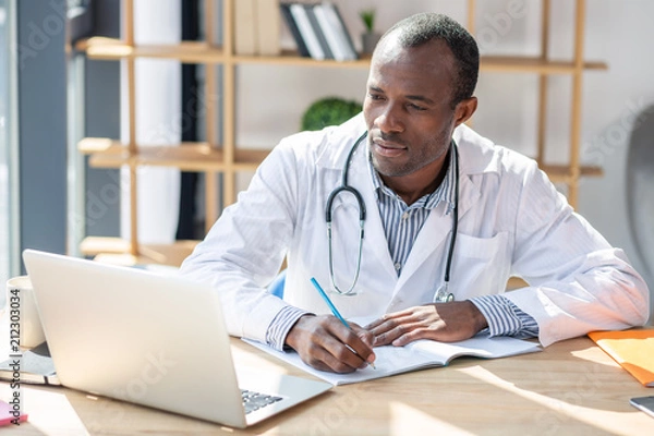 Obraz Concentrated foreigner preparing his scientific work