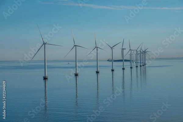 Fototapeta offshore windmill park alternative energy. windmills in the sea with reflection in the morning, denmark