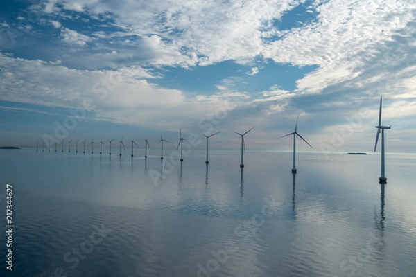Fototapeta offshore windmill park alternative energy. windmills in the sea with reflection in the morning, denmark