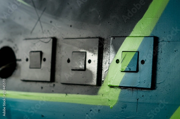Obraz Drei Lichtschalter mit Graffitis übermalt