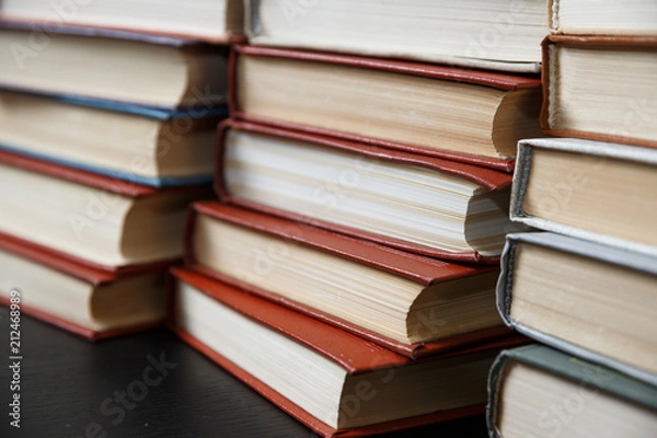 Fototapeta Stack of books background. many books piles.