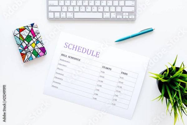 Fototapeta College or school schedule with lessons and bell time. Student planner on white work desk with computer and pen top view