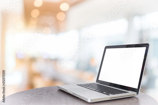 Fototapeta Computer notebook with a coffee shop behind the scenes Blur coffee shop, Blur restaurant