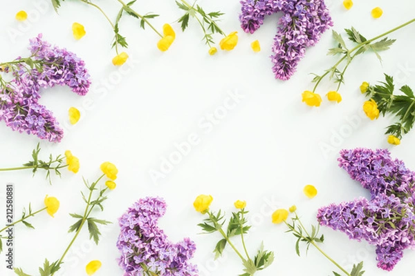 Obraz Lilac and yellow flowers on turquoise background. Flat lay, top view