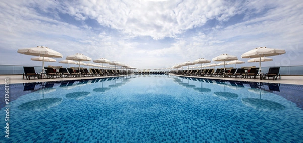 Fototapeta Infinity pool and sun beds