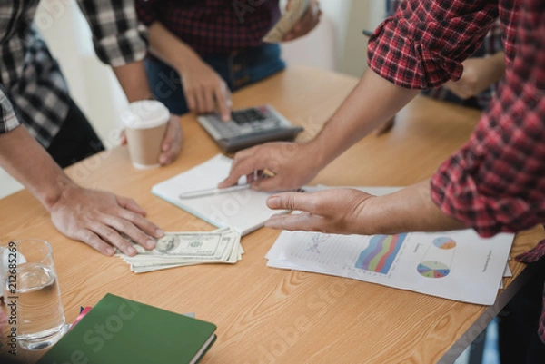 Fototapeta Hand of businessmen group discussing. They are business analyzing. brainstorming, teamwork, meeting concept.
