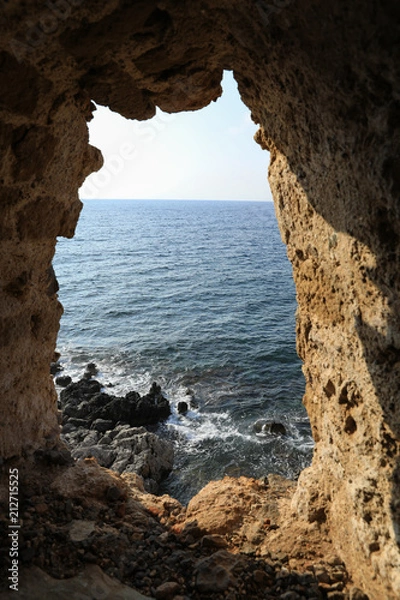 Fototapeta Beautiful seascape view through loophole of Monemvasia medieval castle overlooking the Aegean sea. Monemvasia, Peloponnese, Greece, June 2018.