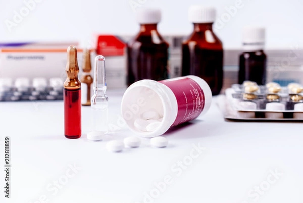 Obraz Ampoules and medical preparations on white table