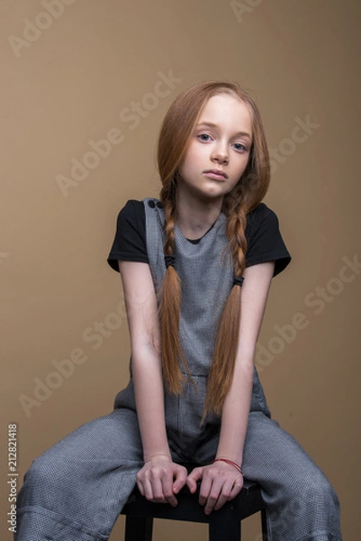 Fototapeta Studio shot of beautiful young redhead girl.