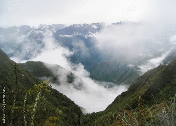 Fototapeta Panoramic view from the Inca Trail of the Sacred Valley with intense low clouds on the Andes mountains. Peru. South America. No people.