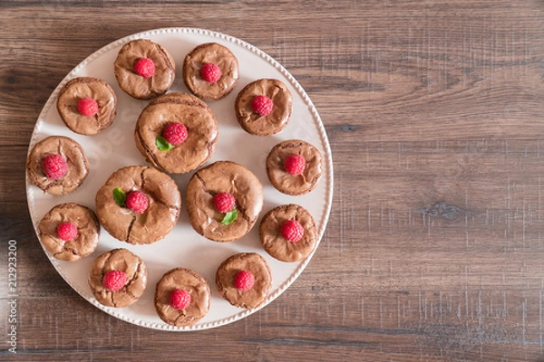 Fototapeta Delicious chocolate lava cakes with fresh raspberries and mint, on the plate