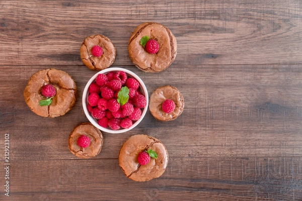 Fototapeta Delicious chocolate lava cakes with fresh raspberries and mint