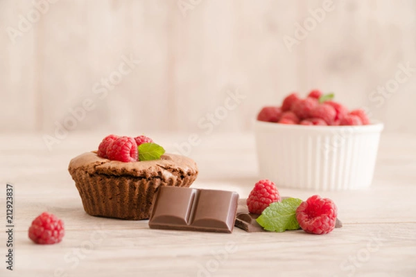 Fototapeta Delicious chocolate lava cake with fresh raspberries, mint and bowl of raspberries
